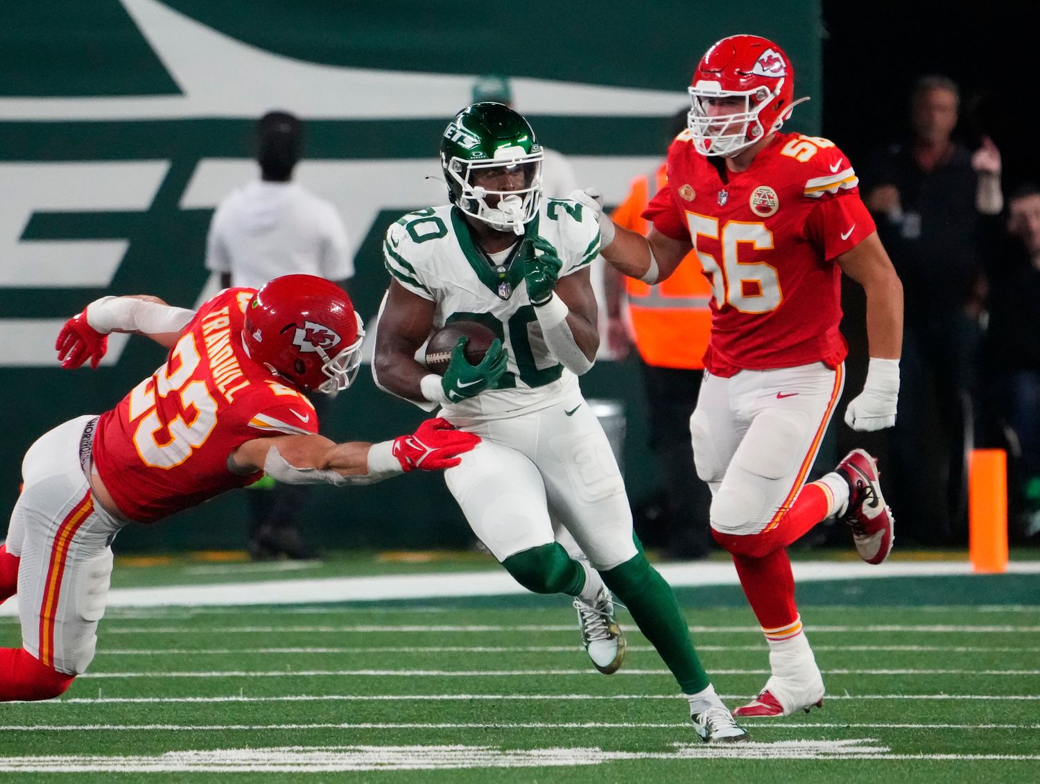 Jets' RB Breece Hall (20) runs through an attempted tackle from a KC defender