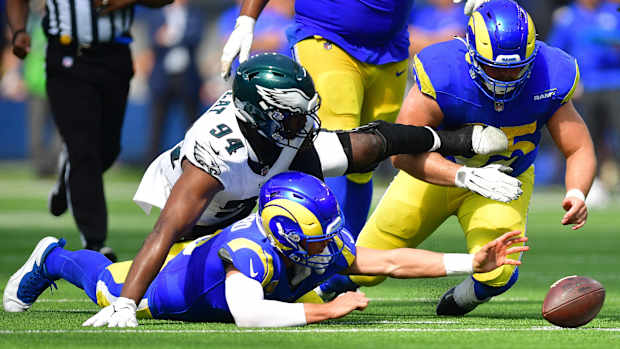 Oct 8, 2023; Inglewood, California, USA; Philadelphia Eagles defensive end Josh Sweat (94) moves in for the ball as Los Angeles Rams guard Coleman Shelton (65) helps quarterback Matthew Stafford (9) recover during the first half at SoFi Stadium. Mandatory Credit: Gary A. Vasquez-USA TODAY Sports