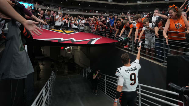 Oct 8, 2023; Glendale, Arizona, United States; Cincinnati Bengals quarterback Joe Burrow (9) high-fives fans after their 34-20 win over the Arizona Cardinals at State Farm Stadium.