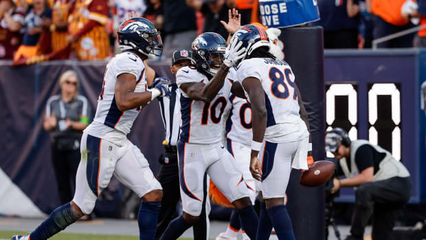Denver Broncos wide receiver Brandon Johnson (89) celebrates his touchdown with wide receiver Jerry Jeudy (10) and wide receiver Courtland Sutton (14) in the fourth quarter against the Washington Commanders at Empower Field at Mile High.