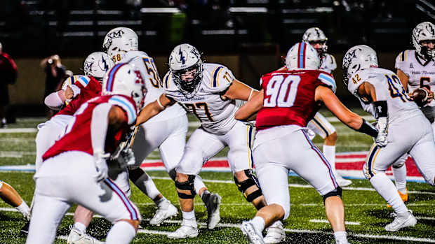 Kettle Moraine offensive lineman Brayden Thompson (77) holds off multiple defenders during the game at Arrowhead on Friday, Sept. 1, 2023.