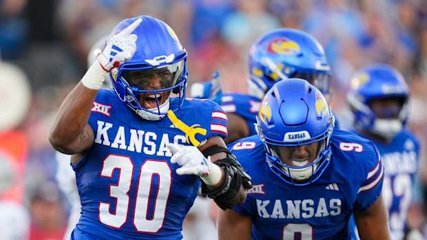Sep 1, 2023; Lawrence, Kansas, USA; Kansas Jayhawks linebacker Rich Miller (30) and defensive lineman Austin Booker (9) celebrate after a play during the first half against the Missouri State Bearsa at David Booth Kansas Memorial Stadium. Mandatory Credit: Jay Biggerstaff-USA TODAY Sports  