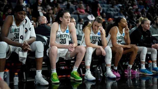 New York Liberty players Jonquel Jones, Breanna Stewart and Sabrina Ionescu sit on the bench as they trail the Las Vegas Aces in Game 2 of the WNBA Finals.