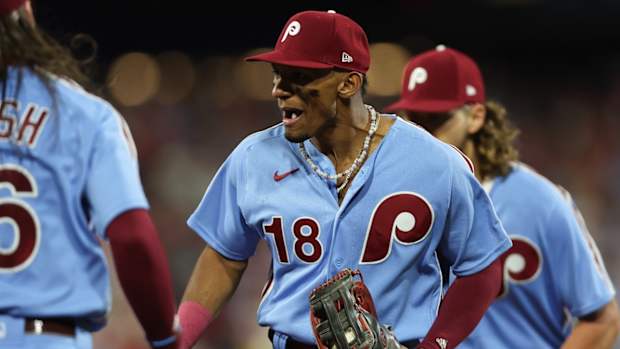 Oct 12, 2023; Philadelphia, Pennsylvania, USA; Philadelphia Phillies center fielder Johan Rojas (18) celebrates after catching the fly ball of Atlanta Braves designated hitter Marcell Ozuna (20) to end the top of the seventh inning during game four of the NLDS for the 2023 MLB playoffs at Citizens Bank Park. Mandatory Credit: Bill Streicher-USA TODAY Sports