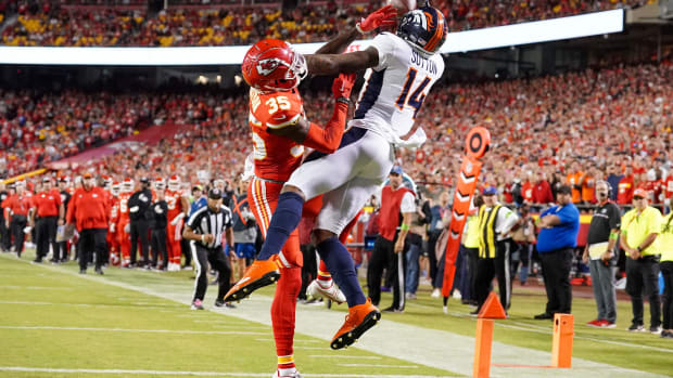 Denver Broncos wide receiver Courtland Sutton (14) catches a pass for a touchdown as Kansas City Chiefs cornerback Jaylen Watson (35) defends during the second half at GEHA Field at Arrowhead Stadium.