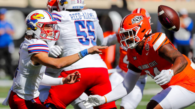 Oct 14, 2023; Stillwater, Oklahoma, USA; Kansas Jayhawks s Jason Bean (9) pitches the ball in the first quarter against the Oklahoma State Cowboys at Boone Pickens Stadium.