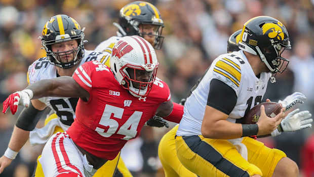 Wisconsin linebacker Jordan Turner (54) sacks Iowa quarterback Deacon Hill (10) on Saturday, October 14, 2023, at Camp Randall Stadium in Madison, Wis. Iowa won the game, 12-6.