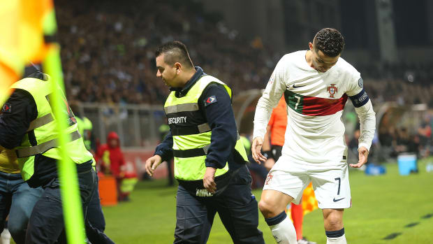Cristiano Ronaldo pictured looking down at his right foot after appearing to have been stood on by a pitch invader during Portugal's 5-0 win over Bosnia and Herzegovina in October 2023