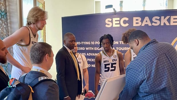 Connor Vanover, Coach Dennis Gates and Sean East II look over the player signs at SEC Tip Off '24