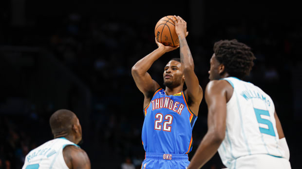 Oct 15, 2023; Charlotte, North Carolina, USA; Oklahoma City Thunder guard Cason Wallace (22) shoots over Charlotte Hornets guard Terry Rozier (3) in the first half at Spectrum Center. Mandatory Credit: Nell Redmond-USA TODAY Sports