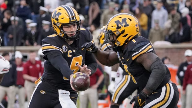 Missouri Tigers quarterback Connor Bazelak (8) hands off to running back Tyler Badie (1) against the South Carolina Gamecocks during the game at Faurot Field at Memorial Stadium in 2021.