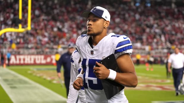 Quarterback Trey Lance jogs off the field during halftime against the San Francisco 49ers