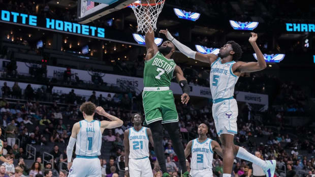 Oct 19, 2023; Charlotte, North Carolina, USA; Boston Celtics guard Jaylen Brown (7) gets a dunk defended by Charlotte Hornets center Mark Williams (5) during the second quarter at Spectrum Center. Mandatory Credit: Jim Dedmon-USA TODAY Sports