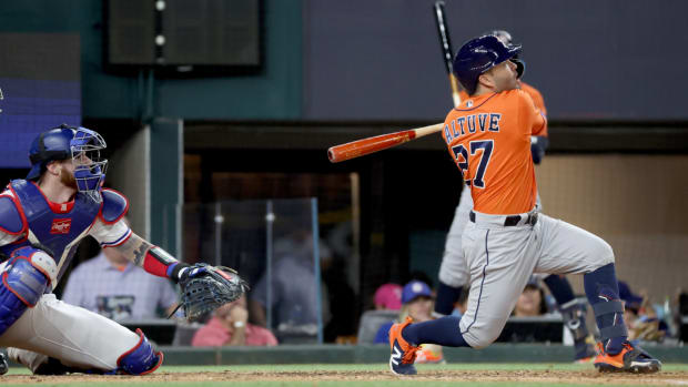 The Astros’ Jose Altuve hits a go-ahead three-run home run against the Rangers in the ninth inning of Game 5 of the 2023 ALCS.