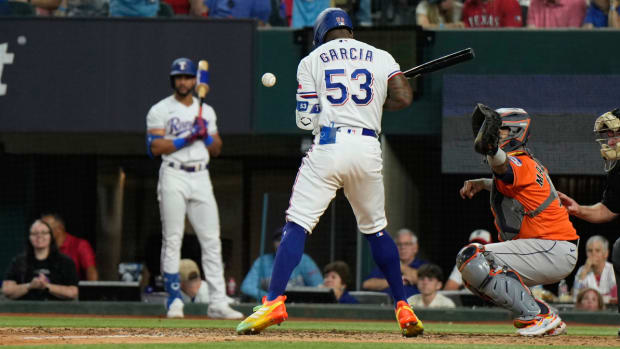 Texas Rangers' Adolis Garcia (53) is hit by a pitch thrown by Houston Astros relief pitcher Bryan Abreu during the eighth inning in Game 5 of the baseball American League Championship Series Friday, Oct. 20, 2023, in Arlington, Texas. (AP Photo/Godofredo A. Vásquez)   