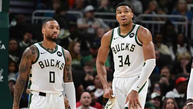 Giannis Antetokounmpo and Damian Lillard on the court.