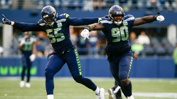 Seattle Seahawks defensive tackle Jarran Reed (90) celebrates with defensive end Frank Clark (55) following a sack against the Los Angeles Chargers during the fourth quarter at CenturyLink Field.