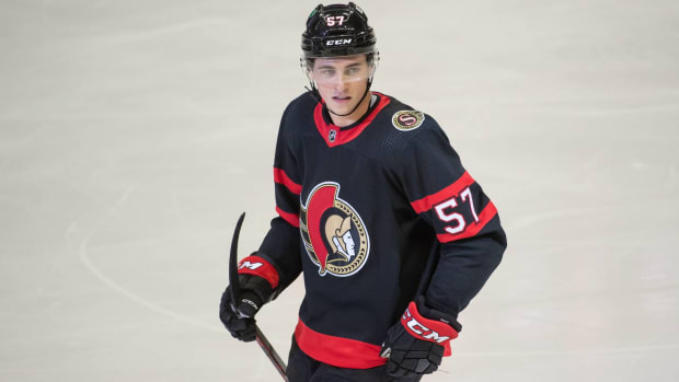 Senators center Shane Pinto looks while holding his stick on during a game.