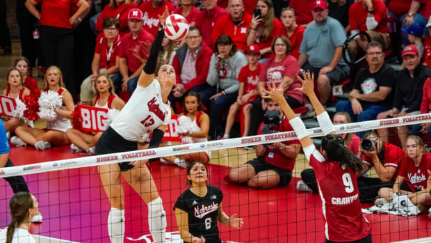 Oct 21, 2023; Lincoln, NE, USA; Nebraska Cornhuskers outside hitter Merritt Beason (13) attacks against Wisconsin Badgers middle blocker Caroline Crawford (9) during the fifth set at the Bob Devaney Sports Center. Mandatory Credit: Dylan Widger-USA TODAY Sports