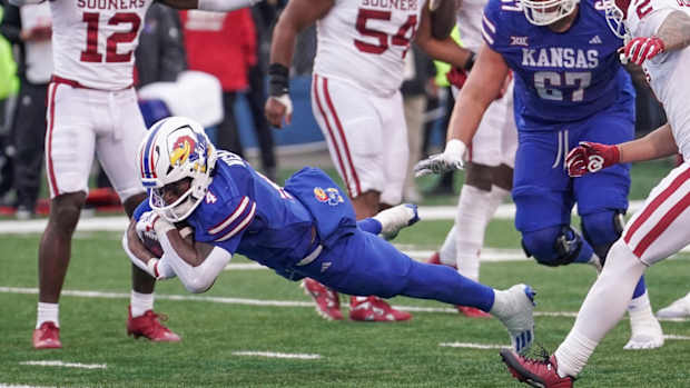 Oct 28, 2023; Lawrence, Kansas, USA; Kansas Jayhawks running back Devin Neal (4) scores the final touchdown against the Oklahoma Sooners during the second half at David Booth Kansas Memorial Stadium.