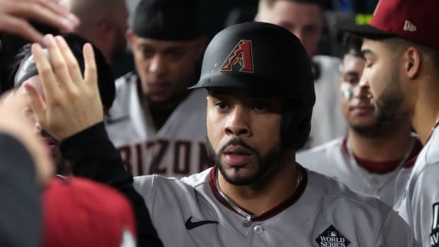 Tommy Pham (pictured) celebrates with his teammates in the dugout after scoring in the third inning of Game 2 of the World Series at Globe Life Field.