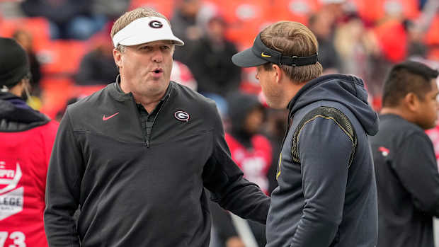 Nov 6, 2021; Athens, Georgia, USA; Georgia Bulldogs head coach Kirby Smart (white visor) and Missouri Tigers head coach Eliah Drinkwitz talk prior to the game at Sanford Stadium. Mandatory Credit: Dale Zanine-USA TODAY Sports