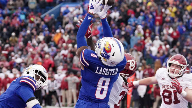Oct 28, 2023; Lawrence, Kansas, USA; Kansas Jayhawks cornerback Kwinton Lassiter (8) nearly intercepts a pass intended for Oklahoma Sooners wide receiver Jalil Farooq (3) during the second half at David Booth Kansas Memorial Stadium. Mandatory Credit: Denny Medley-USA TODAY Sports  