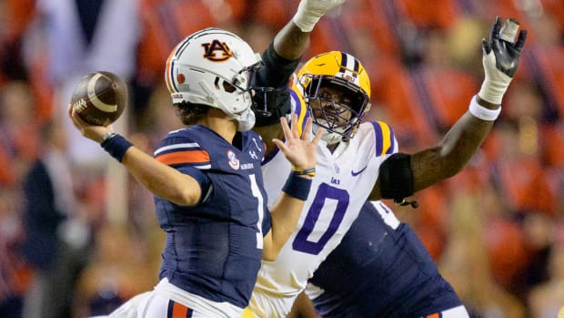 Oct 14, 2023; Baton Rouge, Louisiana, USA; LSU Tigers defensive tackle Maason Smith (0) pressures Auburn Tigers quarterback Payton Thorne (1) during the second quarter at Tiger Stadium. Mandatory Credit: Matthew Hinton-USA TODAY Sports