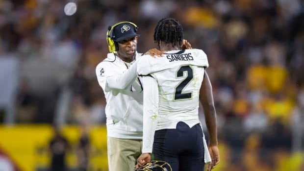 Colorado Buffaloes head coach Deion Sanders with son and quarterback Shedeur Sanders (2) against the Arizona State Sun Devils at Mountain America Stadium