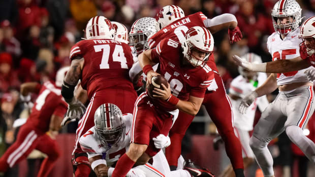 Oct 28, 2023; Madison, Wisconsin, USA; Ohio State Buckeyes cornerback Jordan Hancock (7) pressures Wisconsin Badgers quarterback Braedyn Locke (18) during the first half of the NCAA football game at Camp Randall Stadium.