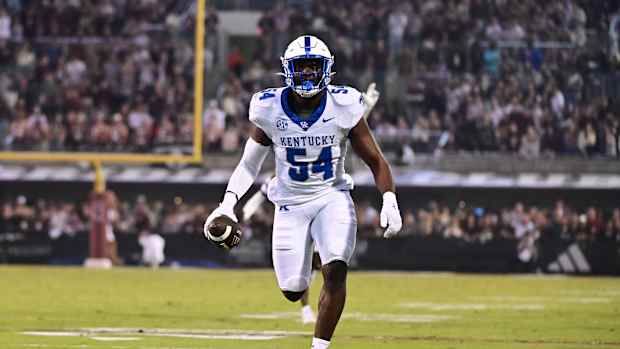 Nov 4, 2023; Starkville, Mississippi, USA; Kentucky Wildcats linebacker D'Eryk Jackson (54) runs the ball after an interception against the Mississippi State Bulldogs during the second quarter at Davis Wade Stadium at Scott Field. Mandatory Credit: Matt Bush-USA TODAY Sports