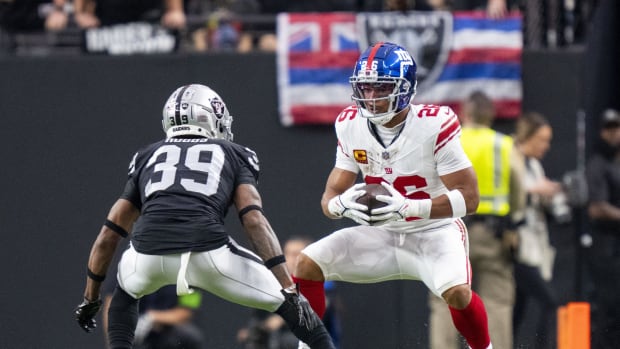 November 5, 2023; Paradise, Nevada, USA; New York Giants running back Saquon Barkley (26) runs the football against Las Vegas Raiders cornerback Nate Hobbs (39) during the first quarter at Allegiant Stadium.