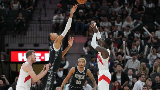 Spurs forward Victor Wembanyama tries to block a shot by Raptors guard Dennis Schröder during Toronto's 123-116 overtime win over San Antonio on Nov. 5, 2023.