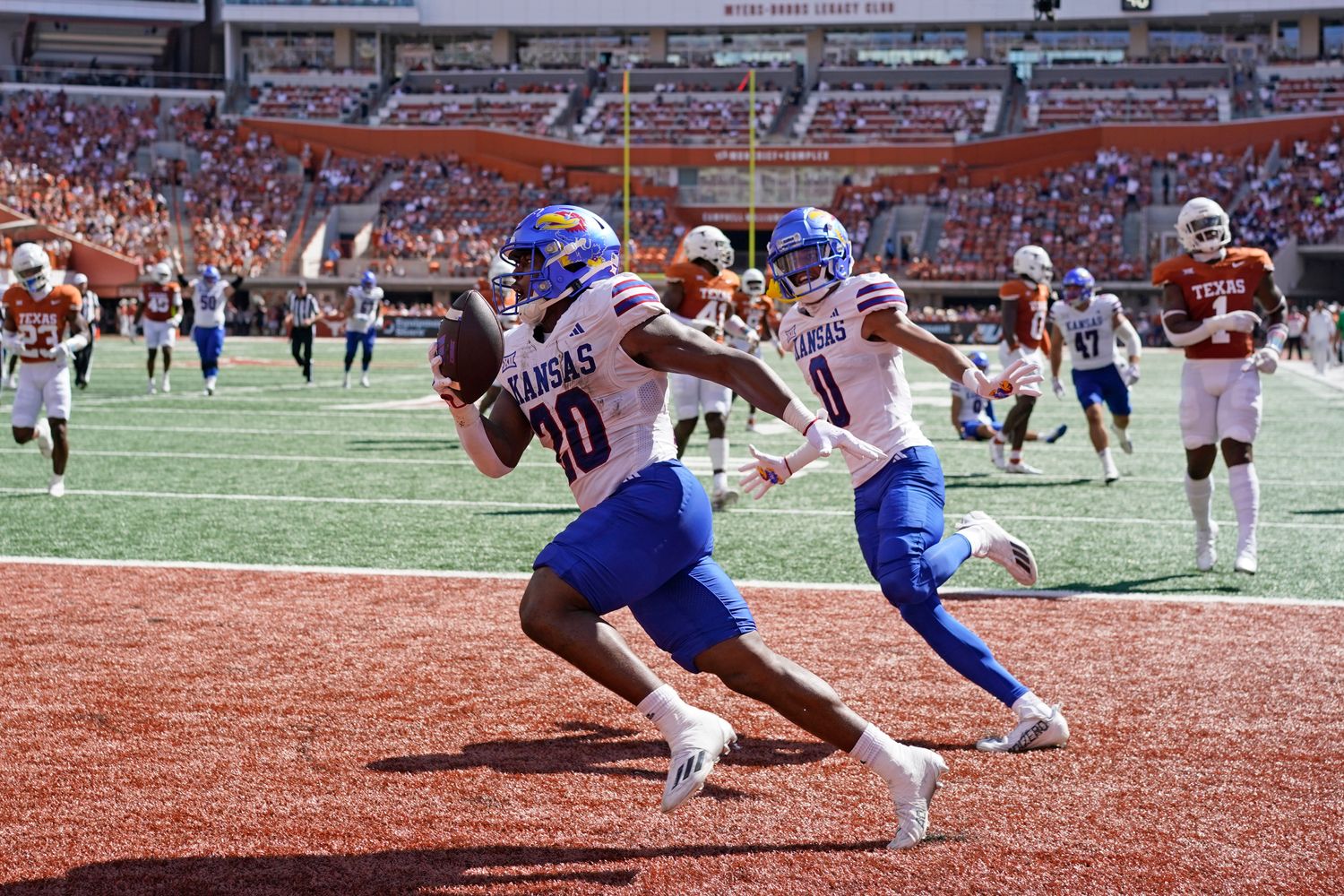 Sep 30, 2023; Austin, Texas, USA; Kansas Jayhawks running back Daniel Hishaw Jr. (20) and wide receiver Quentin Skinner (0) celebrate after Hishaw Jr. scored a touchdown during the first half against the Texas Longhorns at Darrell K Royal-Texas Memorial Stadium. Mandatory Credit: Scott Wachter-USA TODAY Sports  