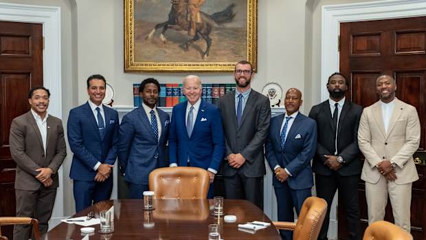 From left: Jordan Meachum, College Football Players Association representative; Kevin Negandhi, ESPN SportsCenter anchor;  Desmond Howard, 1991 Heisman Trophy winner and host of ESPN College Gameday; U.S. president Joe Biden; Former Stanford and Colts quarterback Andrew Luck; ESPN college football analyst Rod Gilmore; Keith Marshall, former Georgia running back and Co-Founder/CEO of the Players' Lounge; Former LSU and Steelers safety and current ESPN analyst Ryan Clark
