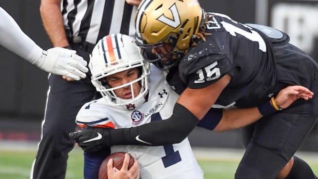 Auburn quarterback Payton Thorne getting slammed by a Vanderbilt defender