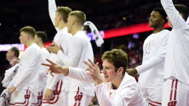 Dec 30, 2022; Madison, Wisconsin, USA; Wisconsin Badgers guard Ross Candelino, front, celebrates a three-pointer by Wisconsin Badgers forward Steven Crowl (not shown) during the second half at the Kohl Center. Mandatory Credit: Kayla Wolf-USA TODAY Sports