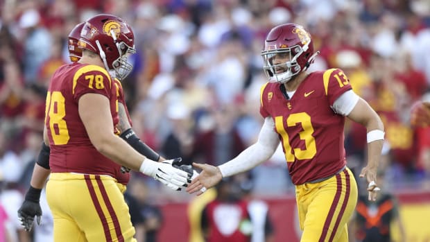 Nov 4, 2023; Los Angeles, California, USA; USC Trojans quarterback Caleb Williams (13) celebrates with USC Trojans offensive lineman Andrew Milek (78) after Caleb Williams (13) scores a touchdown during the first quarter against the Washington Huskies at United Airlines Field at Los Angeles Memorial Coliseum. Mandatory Credit: Jessica Alcheh-USA TODAY Sports  