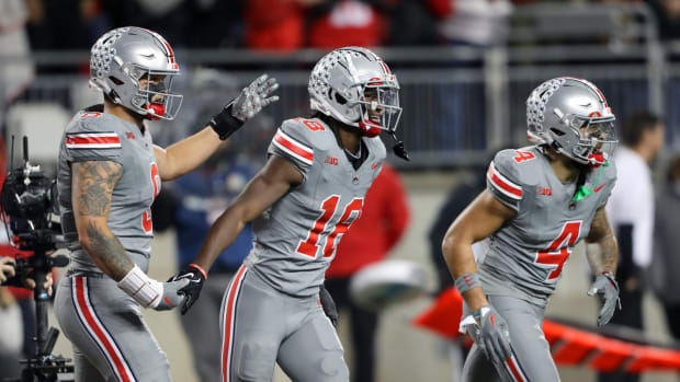 Ohio State Buckeyes wide receiver Marvin Harrison Jr. (18) celebrates the touchdown with tight end Cade Stover (8) and wide receiver Julian Fleming (4) during the first quarter against the Michigan State Spartans