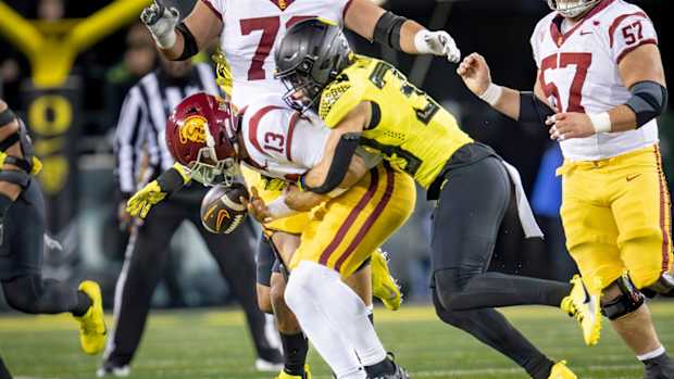 Oregon defensive back Evan Williams forces a fumble from USC quarterback Caleb Williams as the No. 6 Oregon Ducks host the USC Trojans Saturday, Nov. 11, 2023, at Autzen Stadium in Eugene, Ore.  