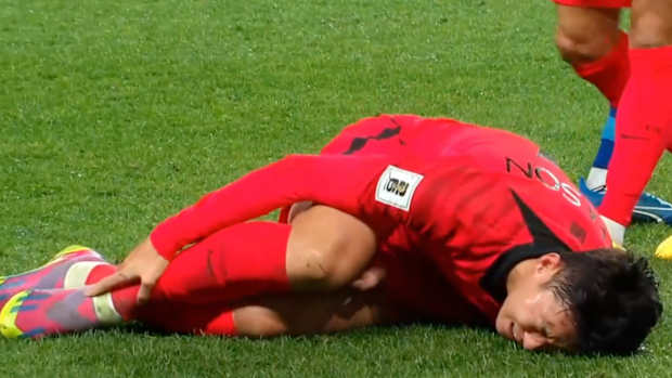 Son Heung-min pictured holding his right leg after being hurt during South Korea's 5-0 win over Singapore in November 2023