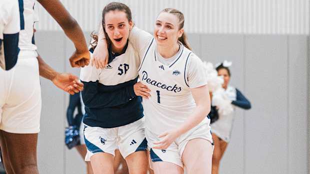 Rachel Kuhl and Lara Aguzzi celebrate Saint Peter’s women’s basketballs first win in more than 600 days.