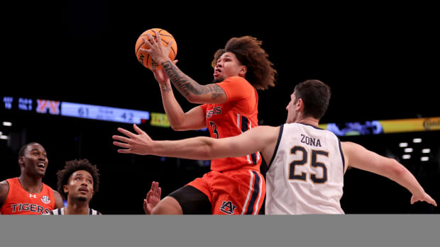 Nov 16, 2023; Brooklyn, New York, USA; Auburn Tigers guard Tre Donaldson (3) drives to the basket against Notre Dame Fighting Irish guard Julian Roper II (1) and forward Matt Zona (25) during the second half at Barclays Center. Mandatory Credit: Brad Penner-USA TODAY Sports 