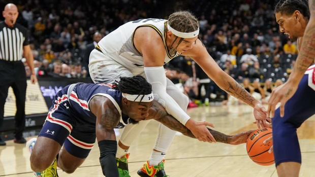 Missouri Tigers forward Noah Carter (35) and Jackson State Tigers forward Jordan O'Neal (23) and guard Chase Adams (10) fight for a loose ball during the first half at Mizzou Arena.
