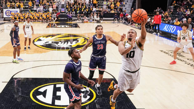 Missouri Tigers guard Nick Honor (10) shoots as Jackson State Tigers guard Keiveon Hunt (5) looks on during the second half at Mizzou Arena.