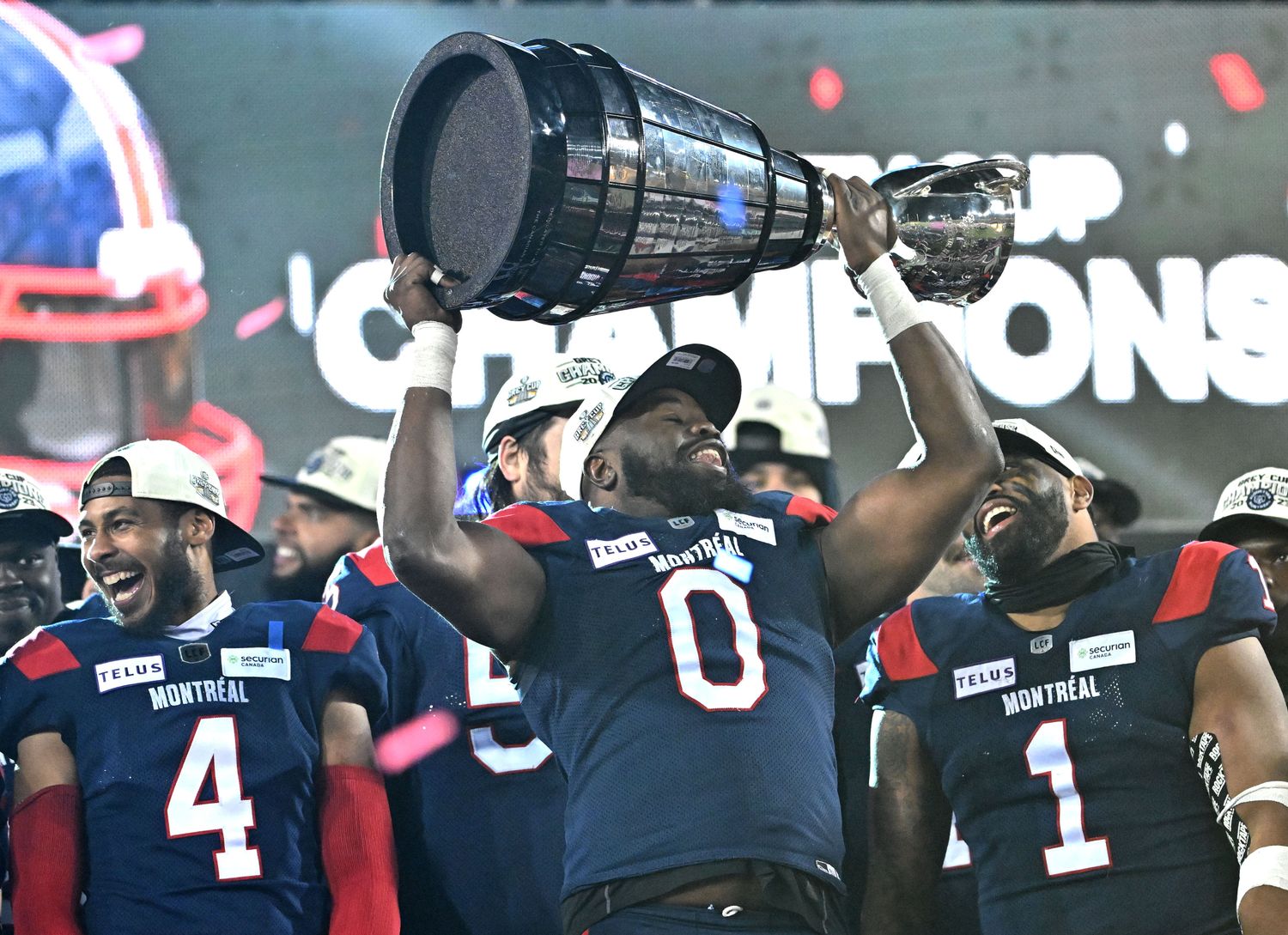 Nov 19, 2023; Hamilton, Ontario, CAN; Montreal Alouettes defensive lineman Shawn Lemon (0) holds up the Grey Cup trophy after defeating the Winnipeg Blue Bombers at Tim Hortons Field. Mandatory Credit: Dan Hamilton-USA TODAY Sports