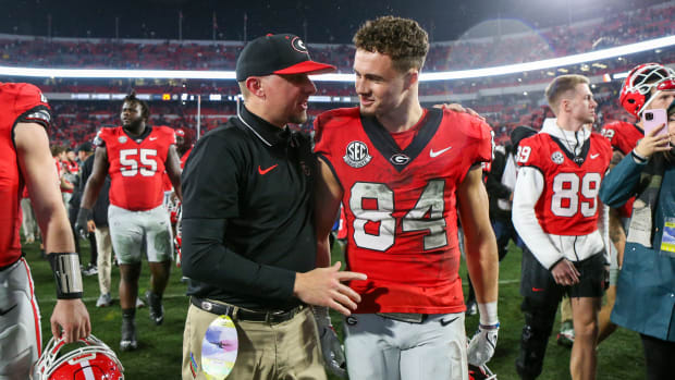 Nov 11, 2023; Athens, Georgia, USA; Georgia Bulldogs tight end coach Todd Hartley talks to wide receiver Ladd McConkey (84) after a victory against the Mississippi Rebels at Sanford Stadium. Mandatory Credit: Brett Davis-USA TODAY Sports