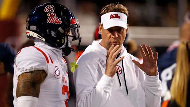 Nov 23, 2023; Starkville, Mississippi, USA; Mississippi Rebels head coach Lane Kiffin (right) talks with defensive back Daijahn Anthony (3) prior to the game against the Mississippi State Bulldogs at Davis Wade Stadium at Scott Field. Mandatory Credit: Petre Thomas-USA TODAY Sports  