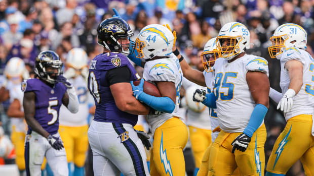 Oct 17, 2021; Baltimore, Maryland, USA; Los Angeles Chargers outside linebacker Kyzir White (44) celebrates an interception in front of Baltimore Ravens guard Kevin Zeitler (70) during the second half at M&T Bank Stadium. Mandatory Credit: Vincent Carchietta-USA TODAY Sports  