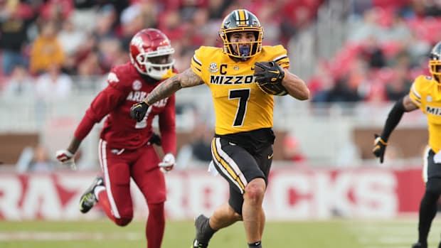 Nov 24, 2023; Fayetteville, Arkansas, USA; Missouri Tigers running back Cody Schrader (7) rushes against the Arkansas Razorbacks during the second quarter at Donald W. Reynolds Razorback Stadium. Mandatory Credit: Nelson Chenault-USA TODAY Sports